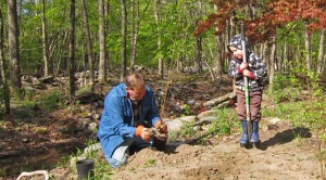 Man and child planting riparian vegetation